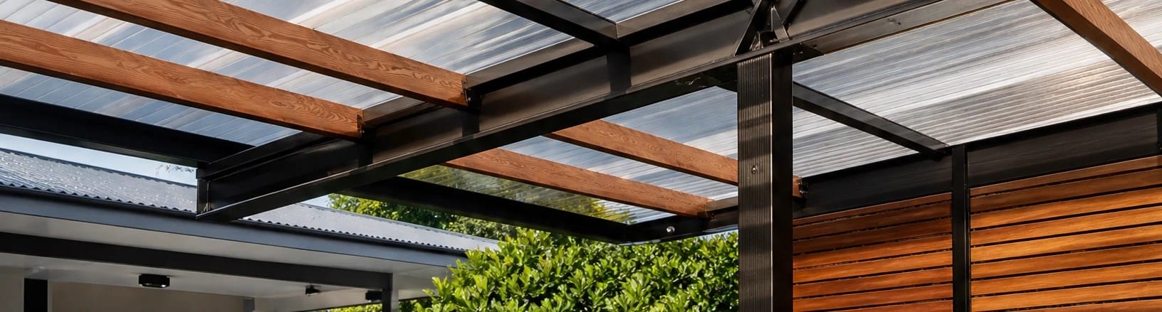 Aerial perspective of a modern carport or patio roof covered with transparent corrugated polycarbonate and PVC light panels_ sunlight shining through the panels creating bright light